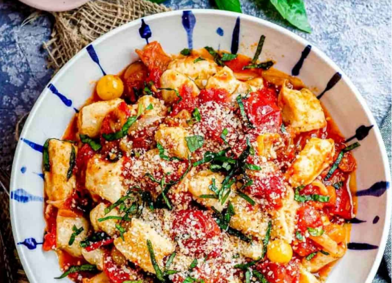 Soft homemade ricotta gnocchi served with butter, Parmesan, and fresh herbs.